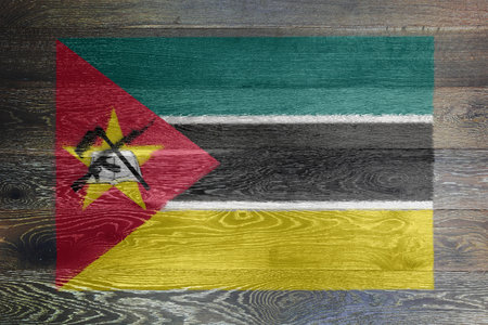Mozambique flag on rustic old woodの写真素材