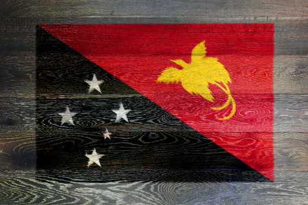 Papua new guinea flag on rustic old wood surface backgroundの写真素材