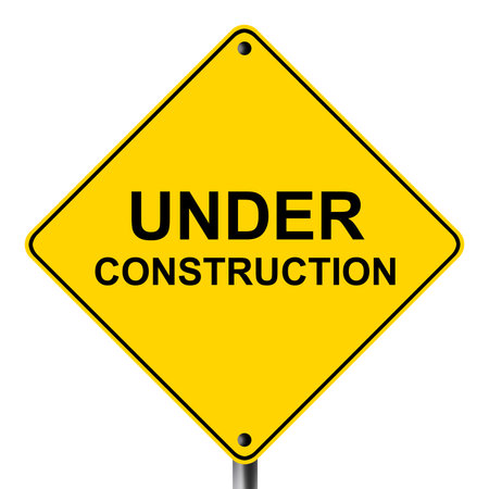 Under construction caution hazard yellow road signの写真素材