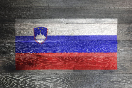 Slovenia flag on rustic old wood surface backgroundの写真素材