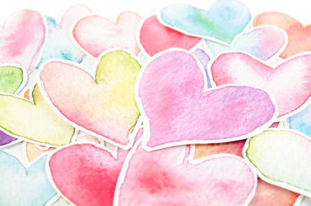 Colorful heart shape arranged on white backgroundの写真素材