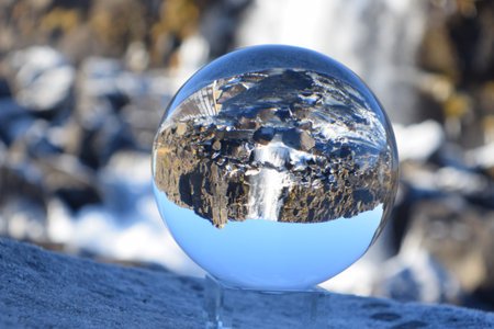 crystal ball on the rock in winter, closeup of photoの写真素材