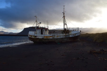 Abandoned fishing boat on the beach in the evening, Iceland