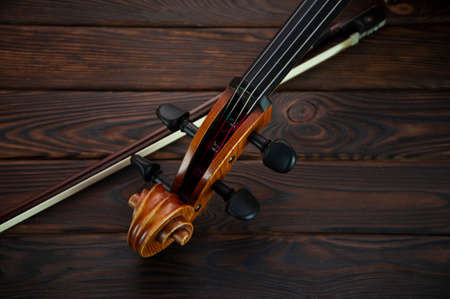 The cello lies on a wooden surface with a bow. Place for textの写真素材
