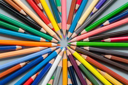 Multi-colored pencils are arranged in a circle in the form of raysの写真素材