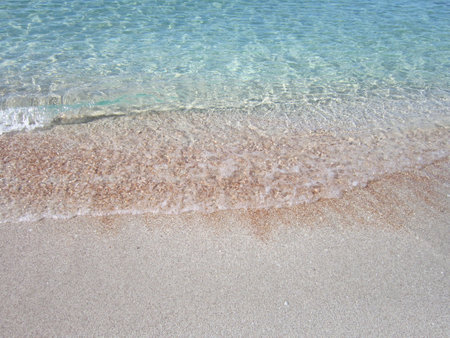 Beautiful beach with crystal clear water and sand with pebblesの写真素材