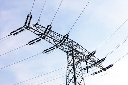 power lines and tower on background of blue sky                                       