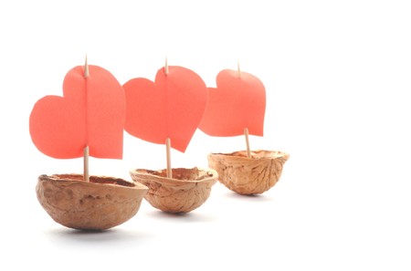 sailboats made of walnuts with a heart sail isolated on white backgroundの写真素材