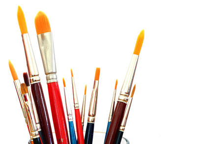 close up of different paint brushes isolated on white background
