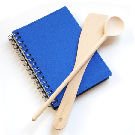 blue cookbook and kitchenware isolated on white backgroundの写真素材