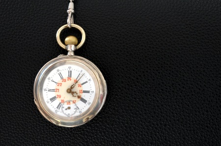 old pocket watch on a  leather textureの写真素材
