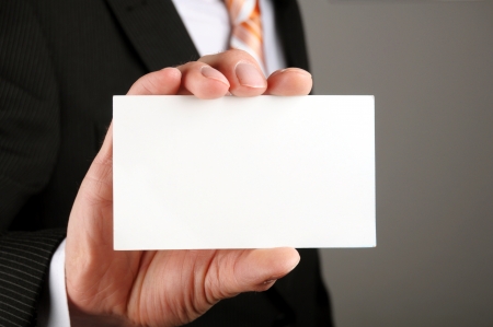 business man showing blank business card or signの写真素材