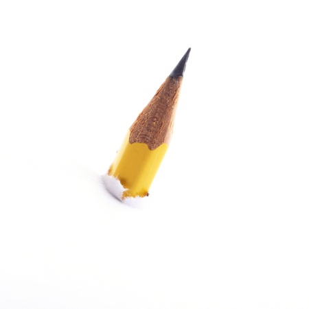 yellow pencil is inserted though white paperの写真素材