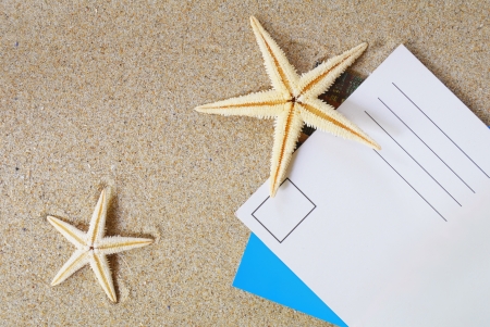 postcard on sand with a lot of beach itemsの写真素材