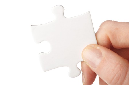 hand with puzzle isolated on white backgroundの写真素材