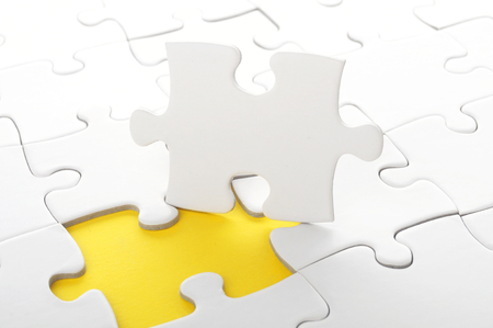 blanck white jigsaw puzzle with missing pieceの写真素材