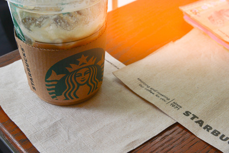 KUALA LUMPUR, MALAYSIA - OCTOBER 23: Starbucks coffee in starbucks offee shop. Glass of Starbuck Coffee Blended Beverages served at wood table.のeditorial素材