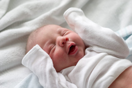 Baby boy making funny faces while sleeping