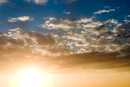 Dramatic sunset with cloudy skies showing bright orange and blue colors