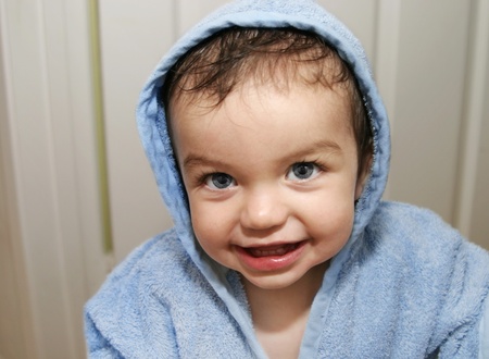 Small boy wearing robe and smiling just after getting out of the bathの写真素材