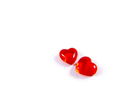 Two red three-dimensional hearts isolated on white background. Good for Valentine's Day greeting card.の写真素材