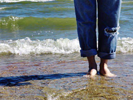 Barefeet standing on a beachの写真素材