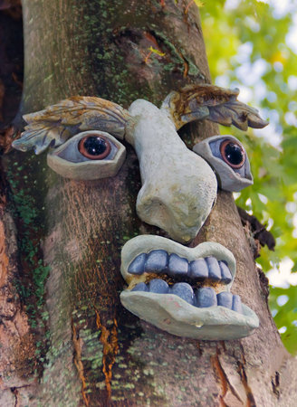 Tree Spirit. Human face decoration on the tree.