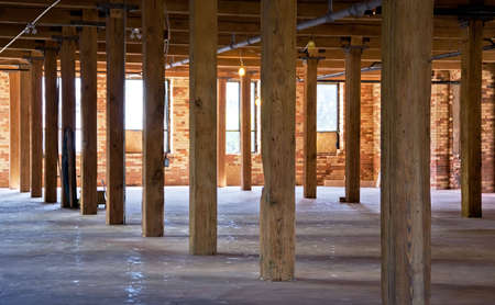 Construction site. Old brick building is under reconstruction for modern office spaces. Wood framing. Renovation.の写真素材