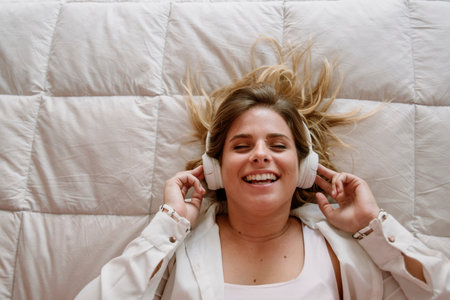 white, caucasian and blond girl, listening music, smiling, and enjoying a lot, with white...