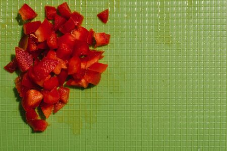 Top view of chopped red bell pepper on a green chopping board.の写真素材