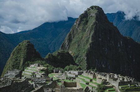 Stock photo of manmade stone structures on a mountain. There are mountains in the background. The sky is cloudy.の写真素材