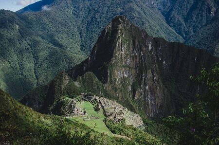 Stock photo of manmade stone structures on a mountain. There are mountains in the background. The sky is cloudy.の写真素材