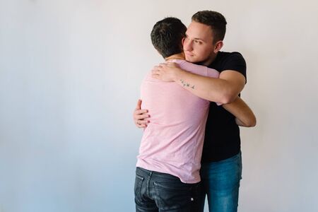 Stock photo of two caucasian homosexual men hugging each other.の写真素材