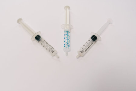 Stock photo of three syringe needle on a white background. There is nobody on the picture.