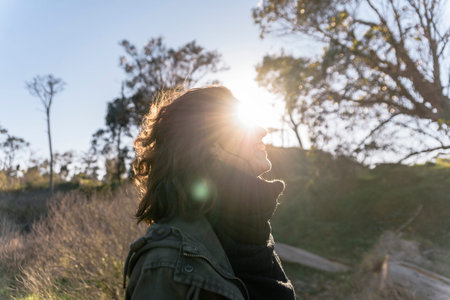 Stock photo of young smiley woman enjoying a day in the countryside.