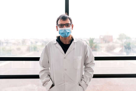 Stock photo of male scientist looking at camera in the hall of a hospital.の写真素材