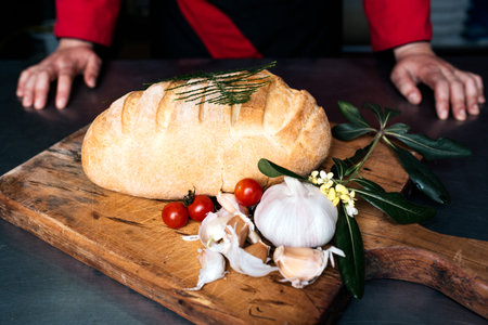Stock photo of freshly baked bread along some garlic cloves.