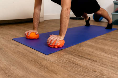Stock photo of unrecognized man doing plank in physiotherapy clinic.の写真素材