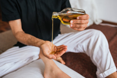 Stock photo of natural therapist using oil for massage with client.の写真素材