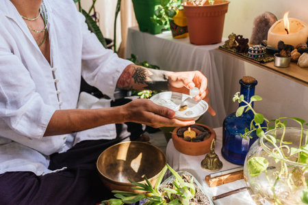 Stock photo of natural therapist preparing plants and oil for massage.の写真素材