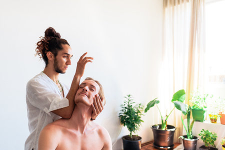Stock photo of relaxed man enjoying neck massage while sitting in a towel.の写真素材