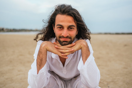 Stock photo of relaxed man with long hair smiling and having fun in the beach.の写真素材