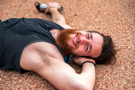 Exhausted sportive man after running and doing work out outdoors.の写真素材