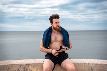 Exhausted sportive man after running and doing work out outdoors.の写真素材