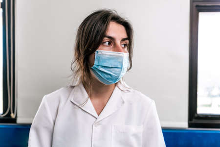 Close up portrait of female scientist wearing face mask in the laboratory.の写真素材