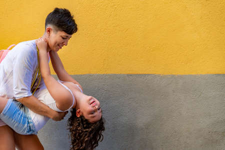 Mother and daughter playing together while going to the beach.の写真素材