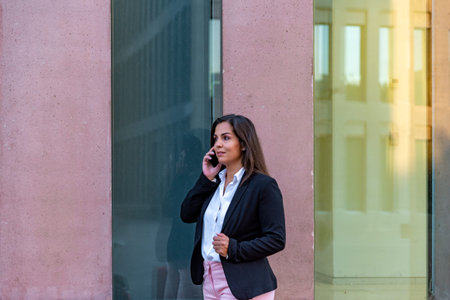 Caucasian businesswoman talking by mobile phone in the cityの写真素材
