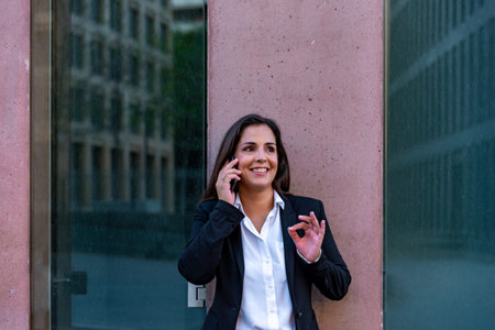 Caucasian businesswoman talking by mobile phone in the cityの写真素材