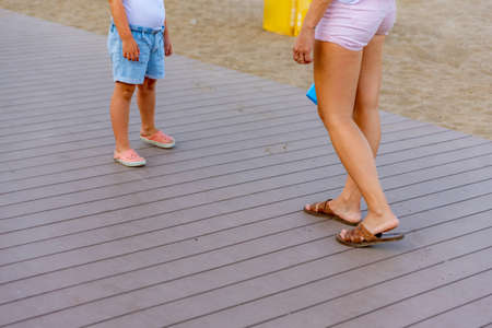 Unrecognizable mother and little daughter in the beachの写真素材