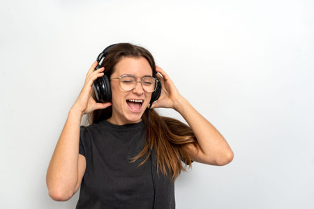 Young latin woman with headphones against white background